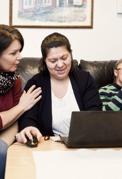 healthcare-worker-helping-woman-with-down-syndrome-XM3VAPY-scaled