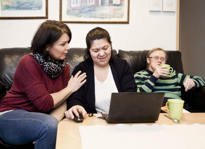 healthcare-worker-helping-woman-with-down-syndrome-XM3VAPY-scaled