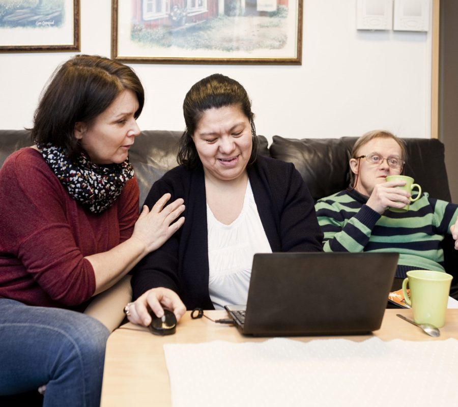 healthcare-worker-helping-woman-with-down-syndrome-XM3VAPY-scaled